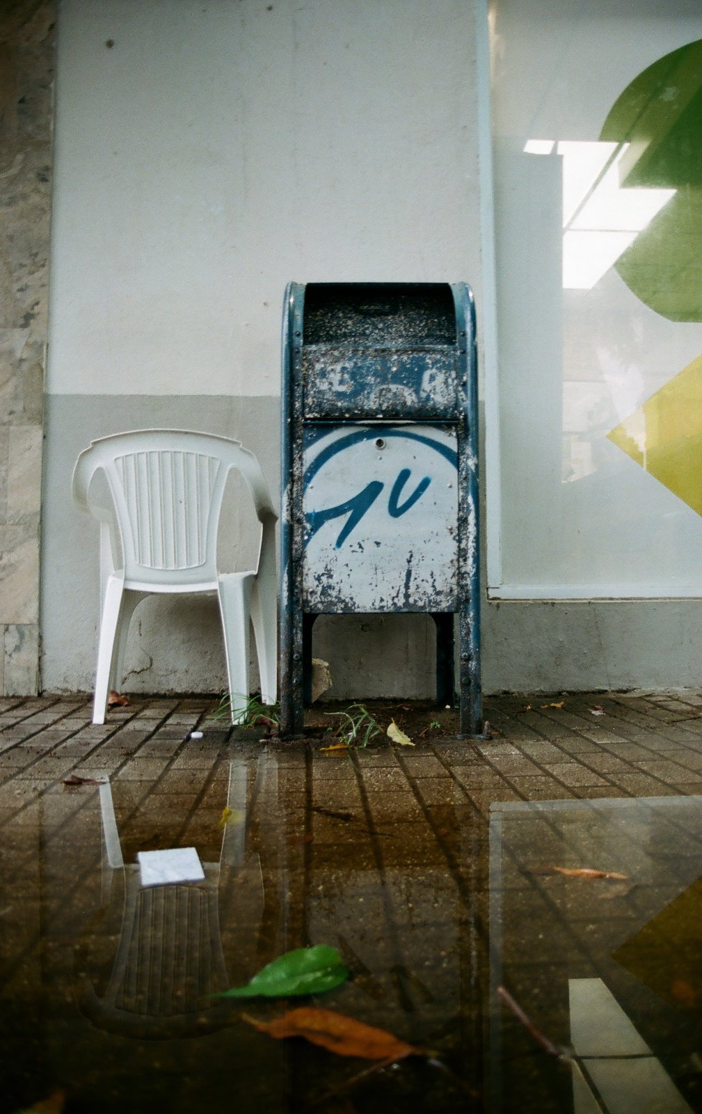 A Mailbox with a chair next to it