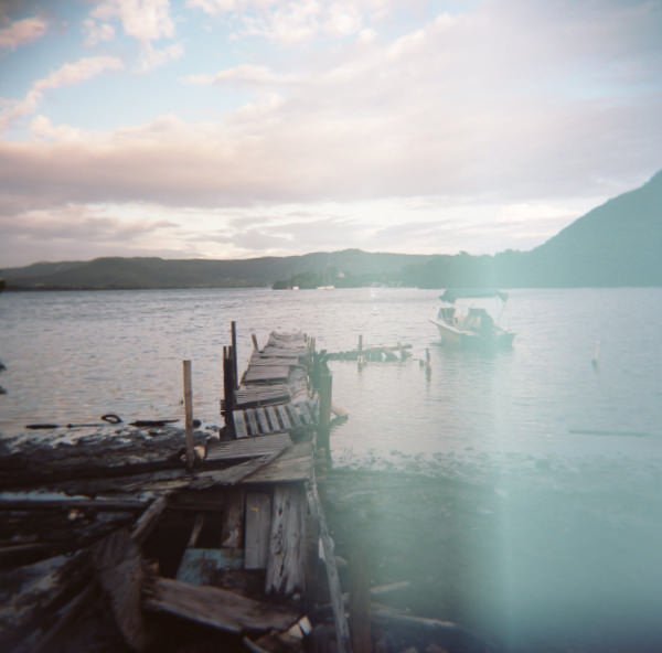A Holga image of a dock with a beautiful light leak that adds to the aesthetic